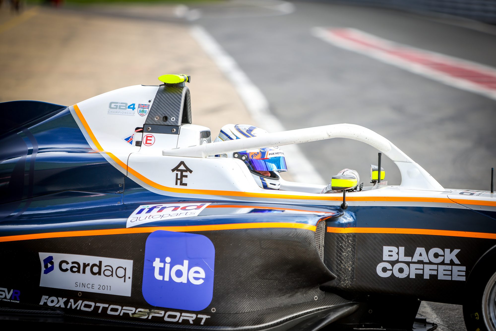 Partner branding on the side of the Fox Motorsport GB4 car, with Robert in the cockpit