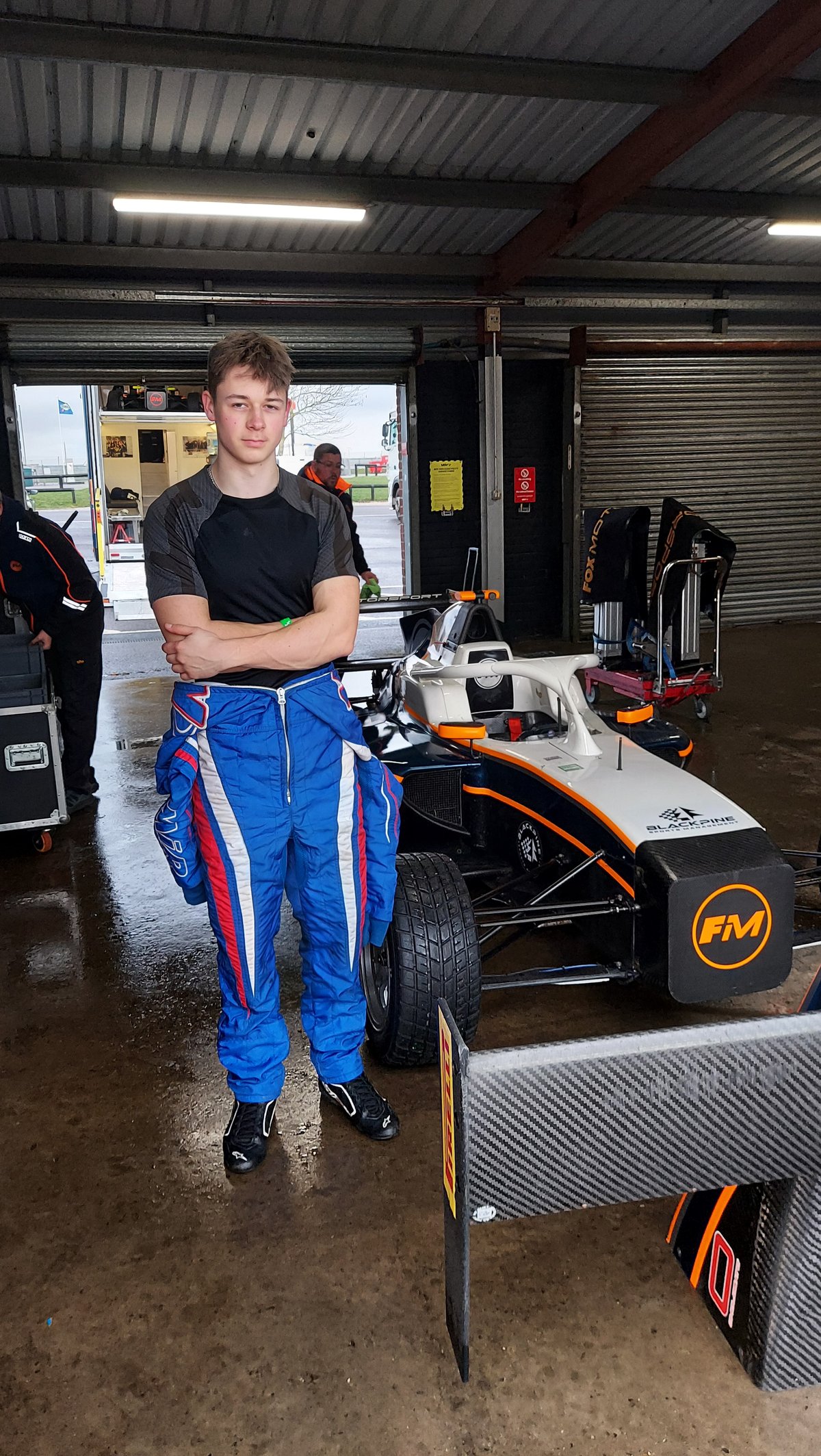 Robert Crawford in race suit alongside the Fox Motorsport GB4 car